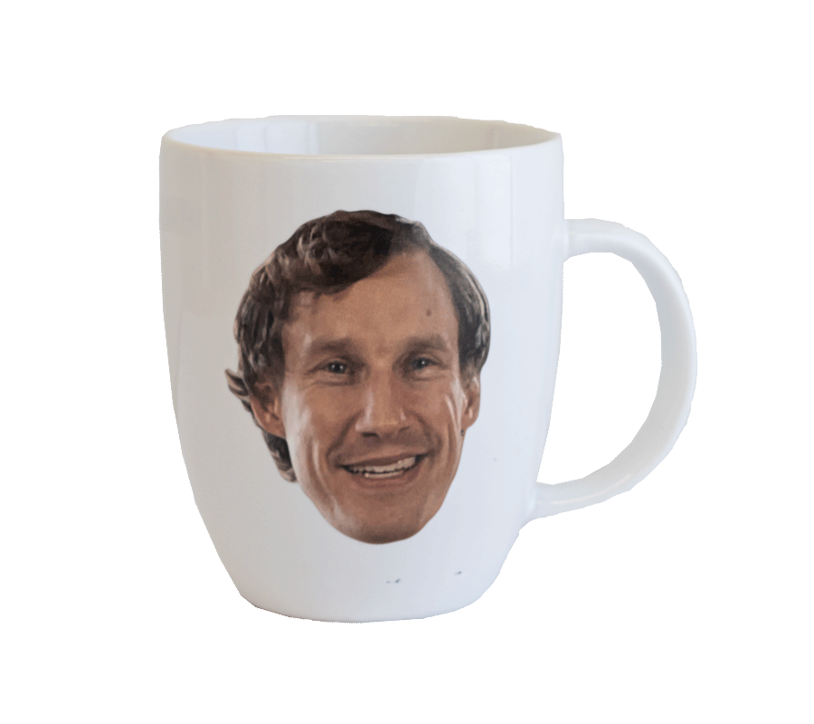 White mug with Norm's smiling face on it